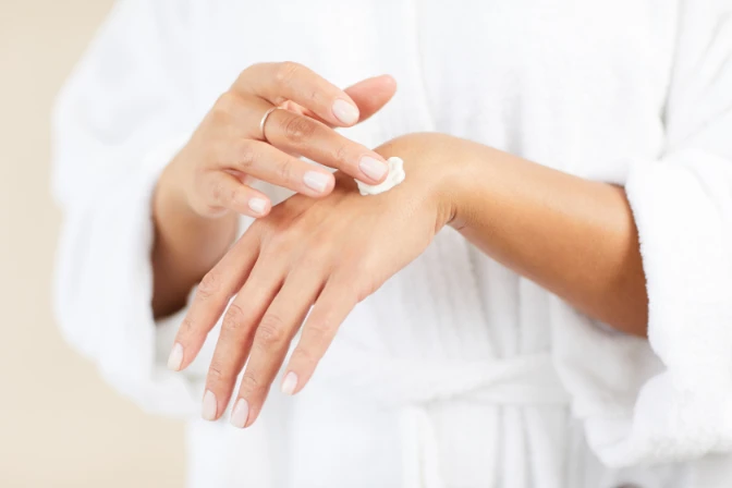 woman putting minerva108 organic anti aging hand cream